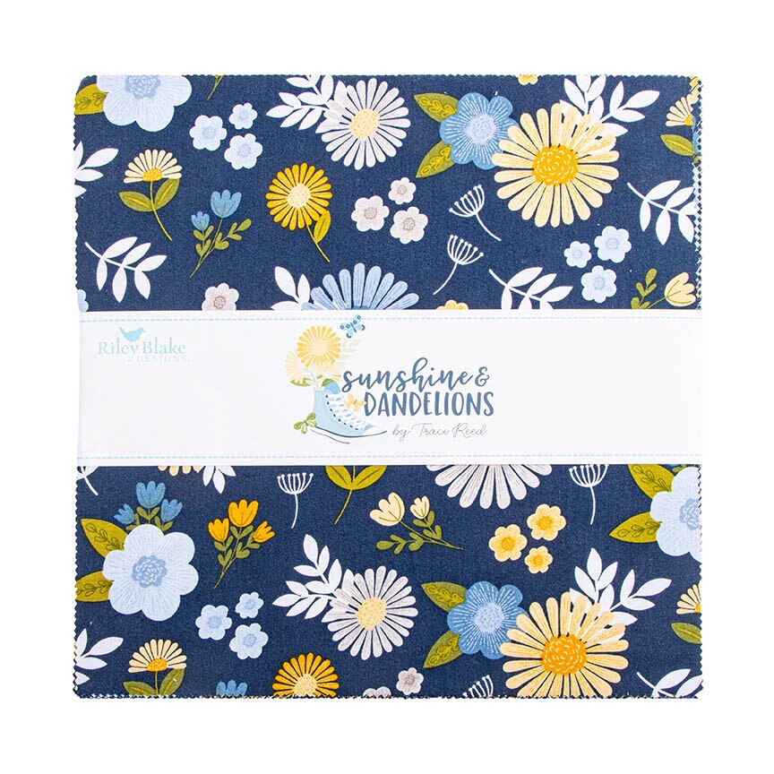 A folded fabric bundle with a floral print on a dark navy background, wrapped in a white paper band labeled Riley Blake Sunshine & Dandelions.