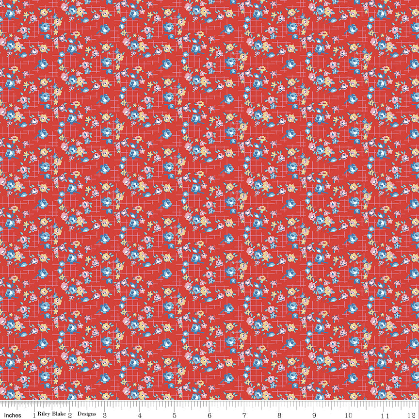 Floral patterned fabric on a red background with a ruler at the bottom.