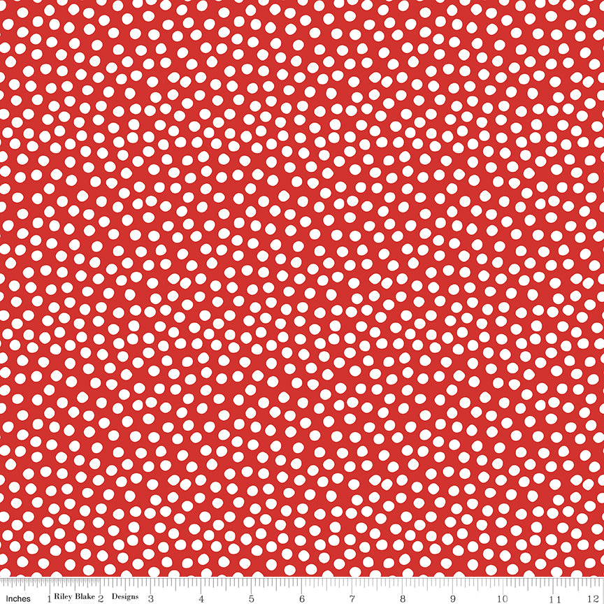 Red fabric with white polka dot pattern, featuring a ruler at the bottom for scale.