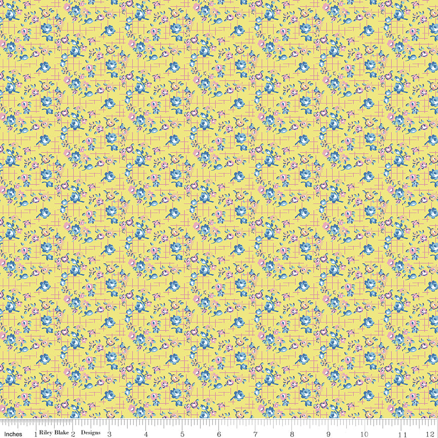 Floral patterned fabric with blue flowers on a yellow grid background