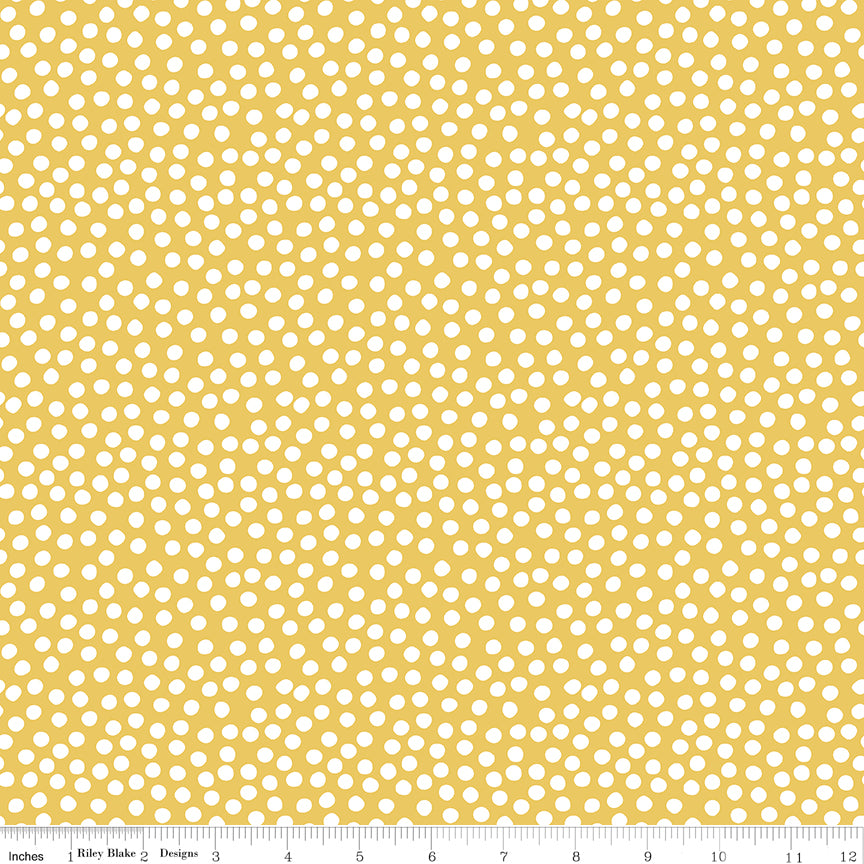 Patterned fabric with white dots on a yellow background
