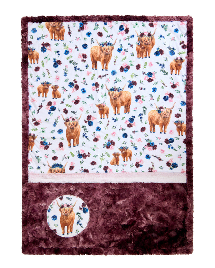 Floral patterned blanket with Highland cows and a circular logo on a white background