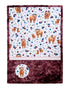 Floral patterned blanket with Highland cows and a circular logo on a white background