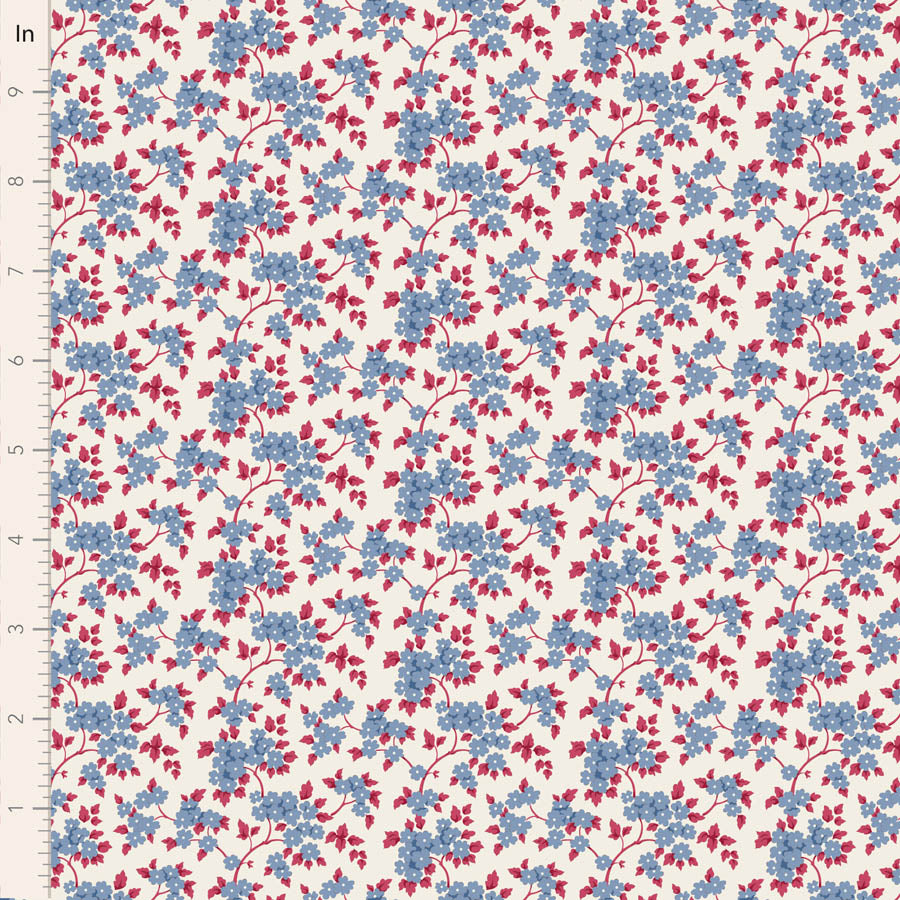 A close-up of a fabric or wallpaper pattern featuring small blue and red flowers on a warm off-white background, with a ruler on the left side showing measurement markings in inches.