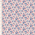 A close-up of a fabric or wallpaper pattern featuring small blue and red flowers on a warm off-white background, with a ruler on the left side showing measurement markings in inches.