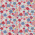 A dense, repeating floral pattern featuring red, pink, blue, and beige flowers with yellow centers on a white background.
