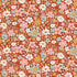Floral pattern with small flowers in pink, white, and blue on a red background