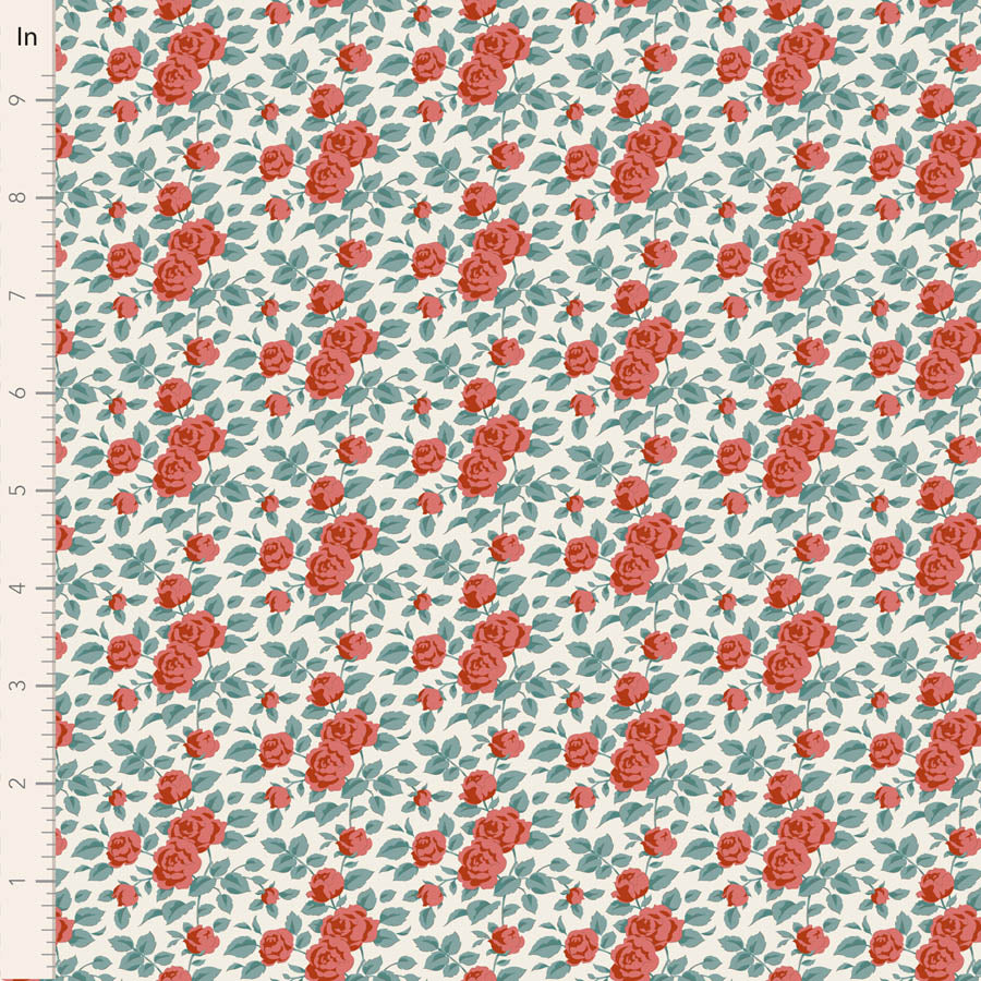 A close-up of a floral fabric pattern featuring red roses and teal leaves on a white background, with a measuring ruler visible along the left edge.