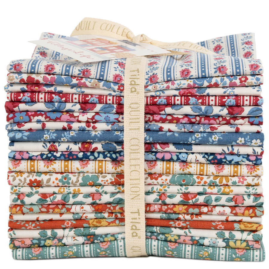 Stack of colorful fabric bundles with a visible brand label on a white background