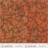Floral patterned fabric with a ruler at the bottom for scale, on a red background.