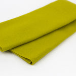 Folded green fabric on a white background