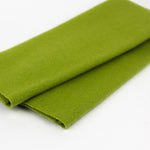 Folded green fabric on a white background