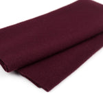 Folded burgundy fabric on a white background