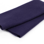 Roll of dark blue fabric on a white background