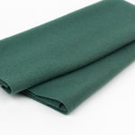 Folded green fabric on a white background