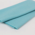 Folded light blue fabric on a white background