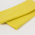 Two yellow fabric swatches on a light gray background