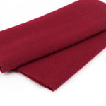 Folded burgundy fabric on a white background