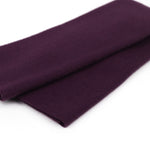 Folded dark purple fabric on a white background