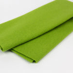 Folded green fabric on a white background