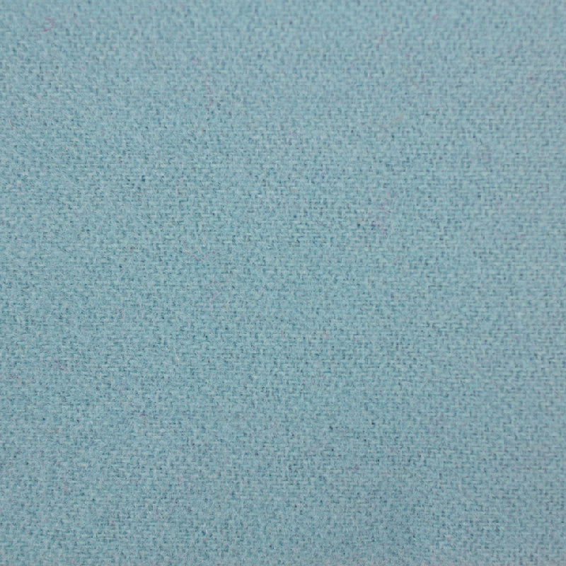 A close-up of a light blue-gray woven fabric texture filling the frame.