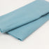 Folded light blue fabric on a white background