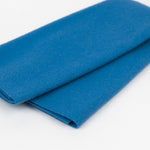 Folded blue fabric on a white background