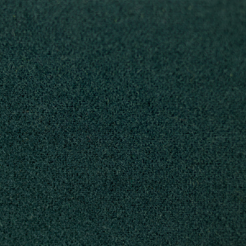 A close-up texture shot of a dark teal green felt or suede-like material.