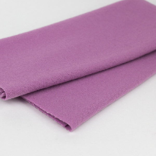 A folded piece of purple wool fabric shown on a plain white background.