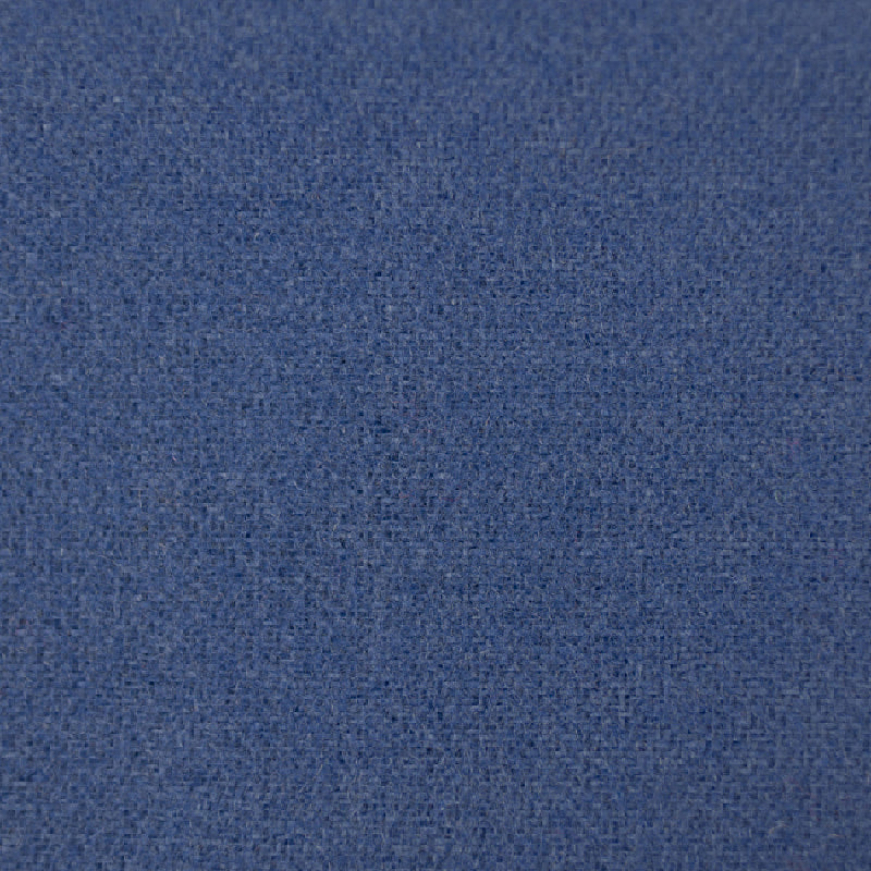 A close-up texture shot of a medium blue woven fabric, showing the detailed weave pattern.