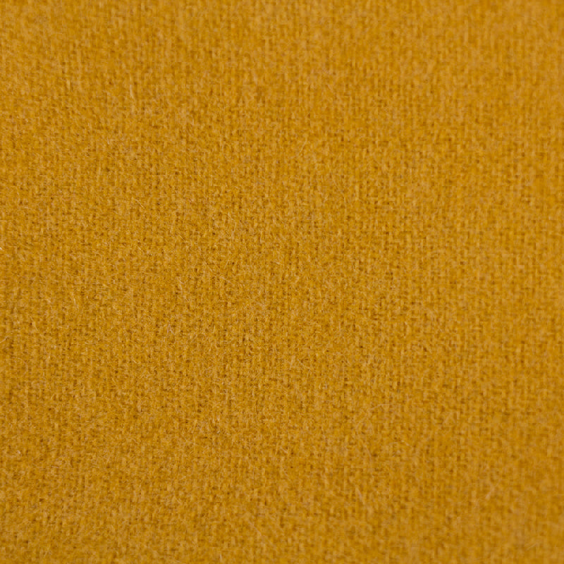 A close-up texture shot of a mustard yellow fabric, showing a fine woven or knit pattern.