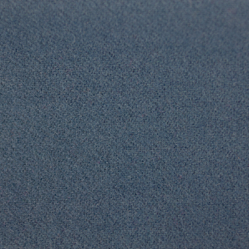 A close-up texture shot of a blue-gray woven fabric, showing the fine knit pattern and subtle heathered color.