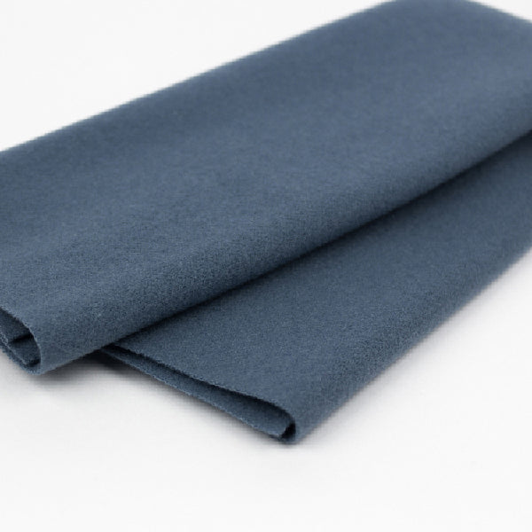 Folded blue fabric on a white background
