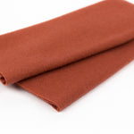 Brown fabric roll on a white background