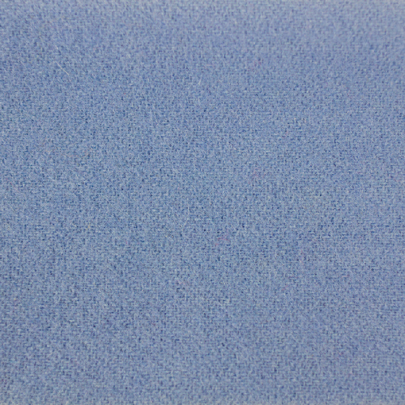 A close-up texture shot of a light blue woven fabric, showing the fine knit pattern.
