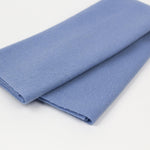 Folded blue fabric on a white background