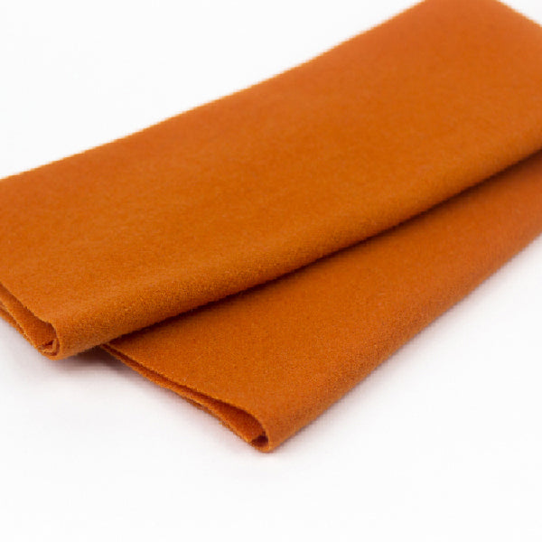 Folded orange fabric on a white background