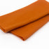 Folded orange fabric on a white background