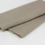 Folded beige fabric on a white background