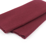 Folded burgundy fabric on a white background
