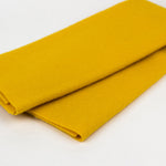 Folded yellow fabric on a white background