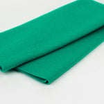 A folded piece of vibrant green felt fabric on a clean white background.