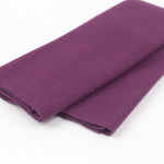 Folded purple fabric on a white background
