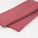 Folded pink fabric on a white background