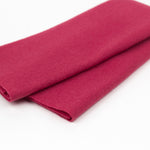 Folded red fabric on a white background