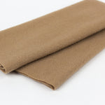 Rolled brown fabric on a white background