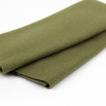 Folded green fabric on a white background