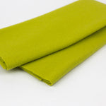 Folded green fabric on a white background