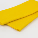 A folded piece of bright yellow fabric, likely felt or fleece, shown on a clean white background.