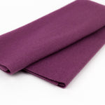 Folded purple fabric on a white background